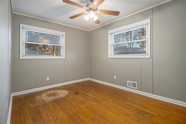 spare room featuring ceiling fan, wood-type flooring, and ornamental molding