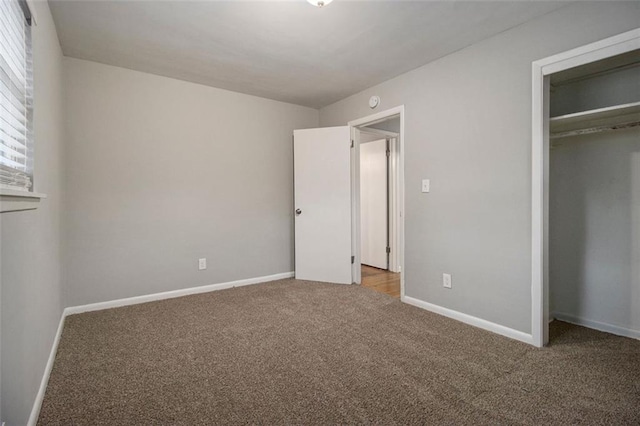 unfurnished bedroom with carpet flooring and a closet