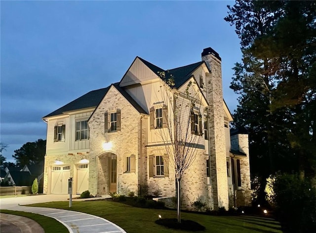 view of front of property with a garage and a front lawn