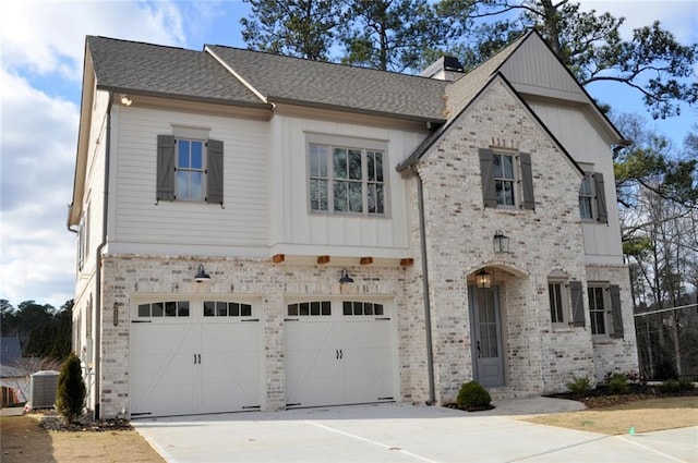 view of front of home featuring cooling unit and a garage