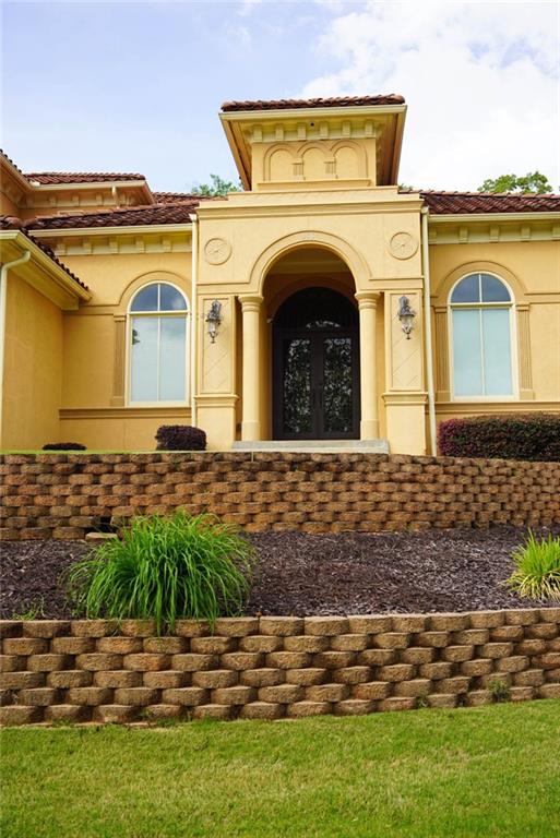 view of exterior entry featuring a tile roof and stucco siding