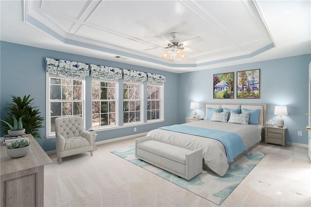 bedroom with ornamental molding, a raised ceiling, light carpet, and baseboards