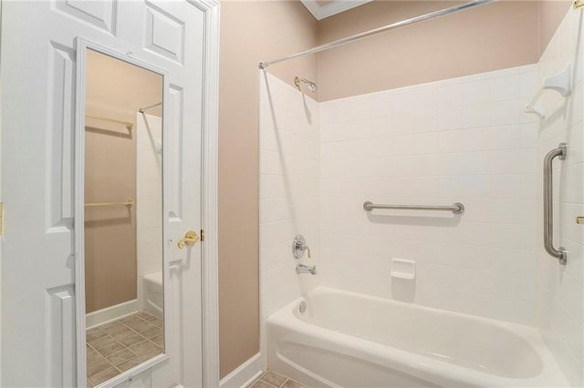 bathroom with tile patterned flooring, bathing tub / shower combination, and baseboards