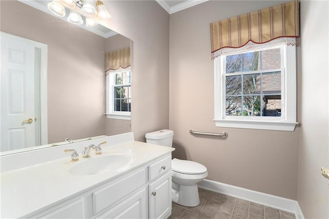 half bathroom with crown molding, toilet, vanity, and baseboards