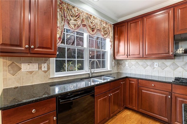 kitchen with black appliances, ornamental molding, dark stone countertops, and a sink