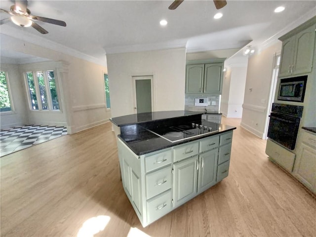 kitchen with crown molding, black appliances, green cabinetry, and ceiling fan