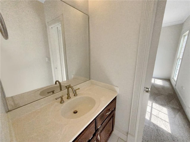 bathroom with vanity, crown molding, and tile patterned flooring