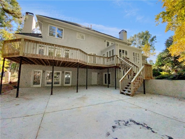 rear view of property featuring a patio and a wooden deck