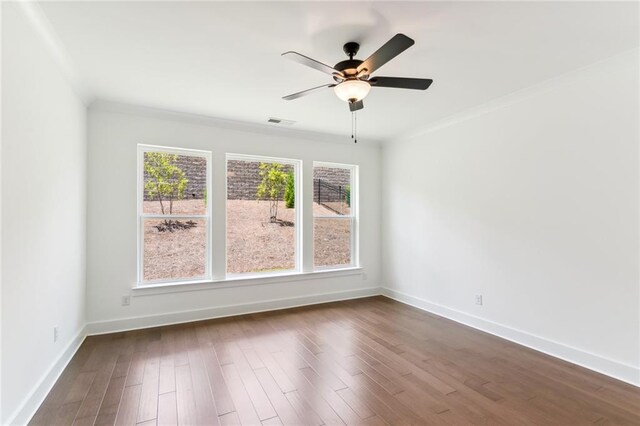 spare room featuring hardwood / wood-style floors, crown molding, and ceiling fan