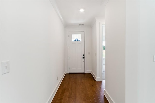 entryway with dark wood-type flooring and crown molding