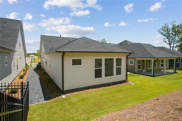 back of house featuring a patio area and a yard