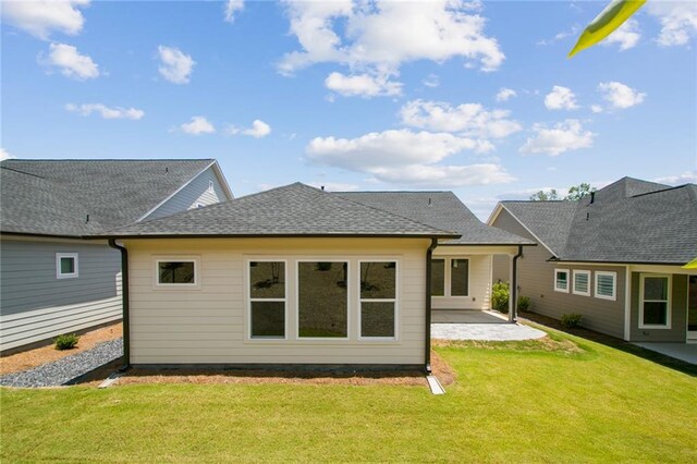 back of house with a yard and a patio area