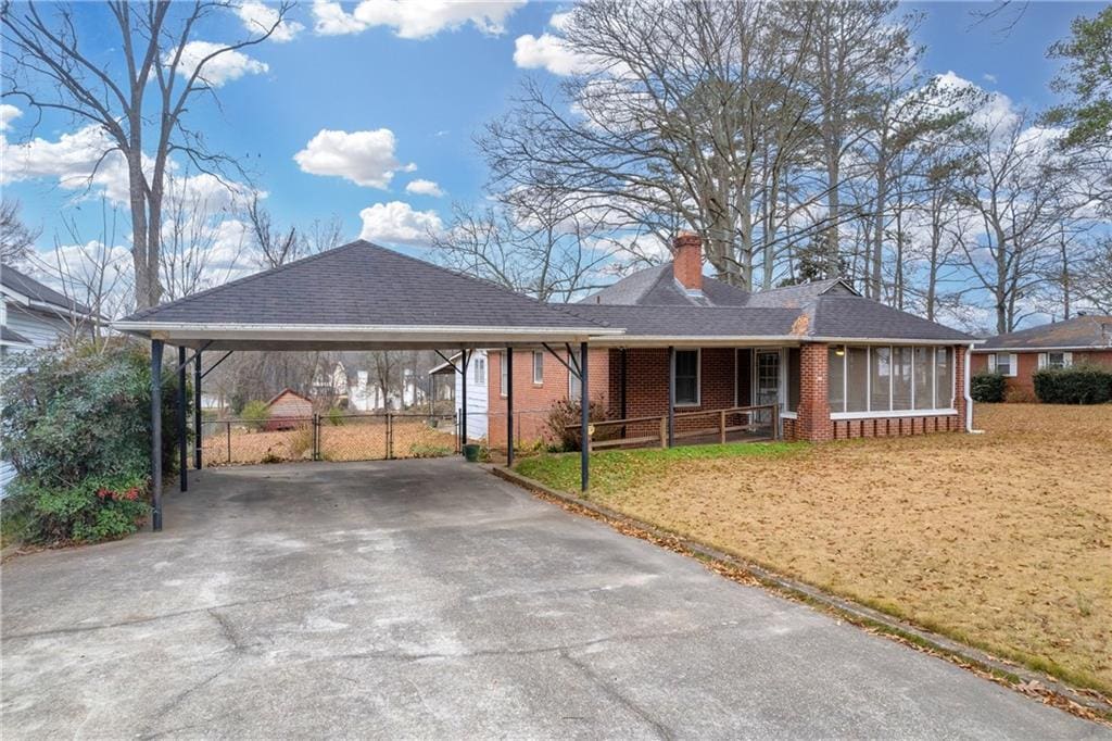 ranch-style house featuring a carport