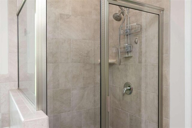 bathroom with a shower with door