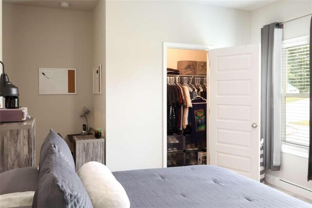 bedroom featuring a spacious closet and a closet