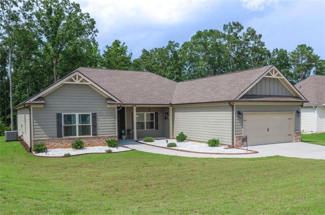 craftsman-style house with a front yard, central AC, and a garage