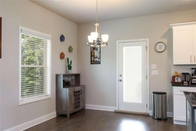 interior space featuring a chandelier and dark wood-type flooring