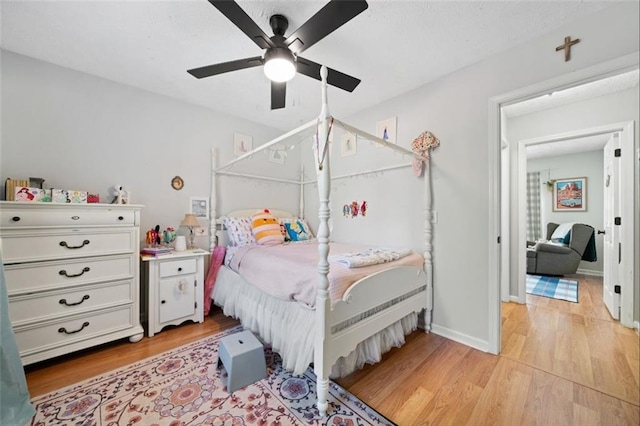 bedroom featuring light wood finished floors and a ceiling fan