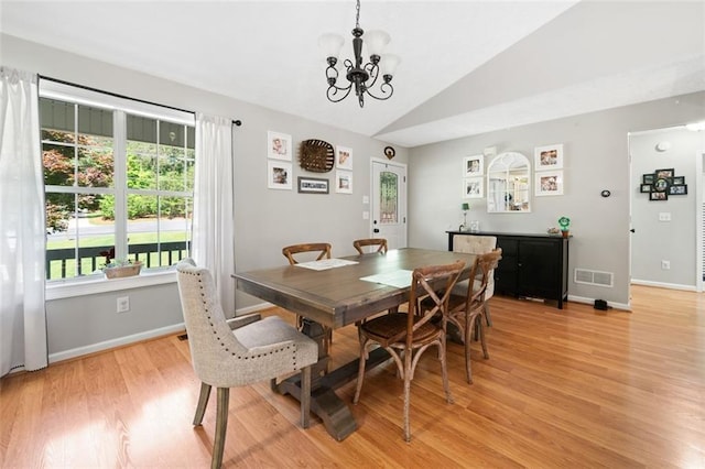 dining space with vaulted ceiling, light wood finished floors, plenty of natural light, a chandelier, and baseboards