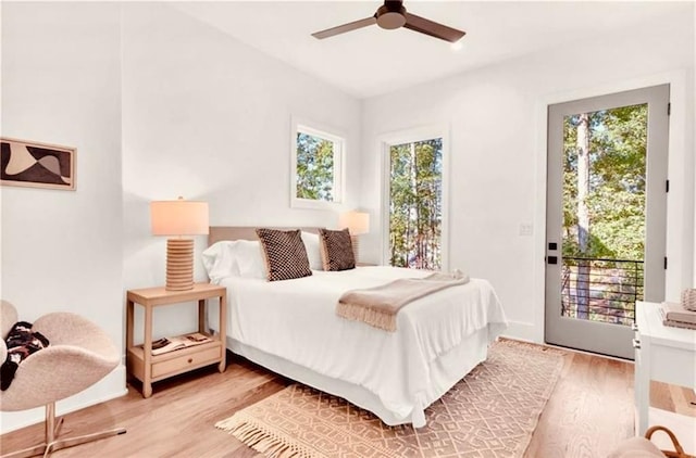 bedroom featuring ceiling fan, light hardwood / wood-style floors, and access to outside