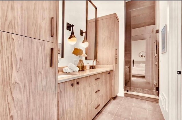 bathroom with vanity, tile patterned flooring, and a shower with shower door