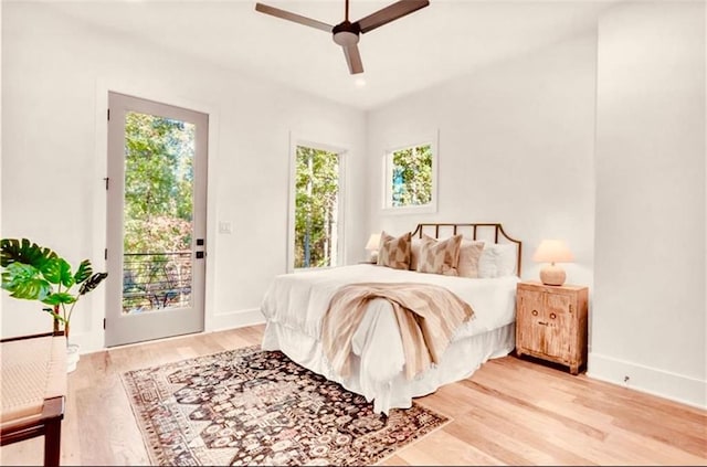 bedroom with ceiling fan, access to outside, and light hardwood / wood-style floors