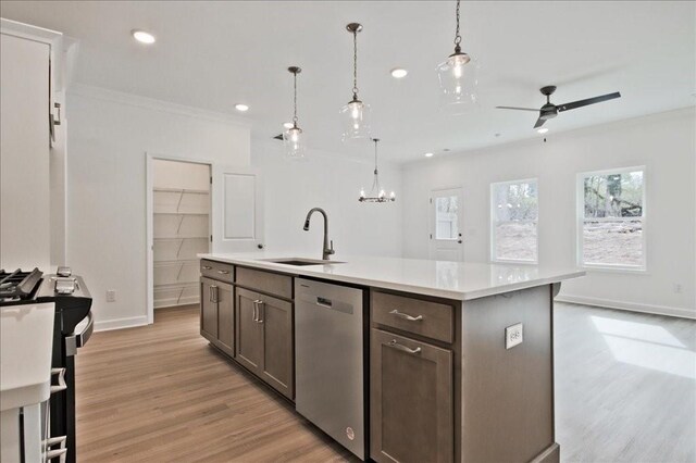 kitchen with light wood-style flooring, a sink, stainless steel dishwasher, recessed lighting, and light countertops