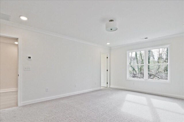 empty room with recessed lighting, baseboards, carpet, and crown molding