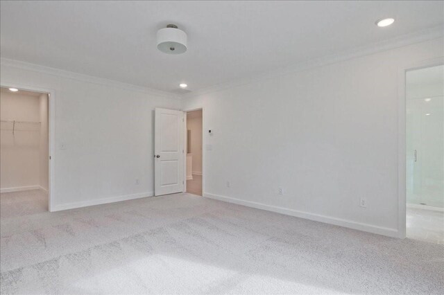 spare room featuring baseboards, carpet, and ornamental molding