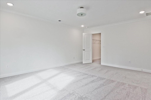 carpeted spare room with recessed lighting, baseboards, and ornamental molding