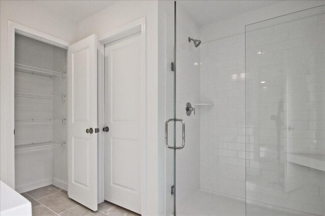 bathroom featuring a shower stall and tile patterned flooring