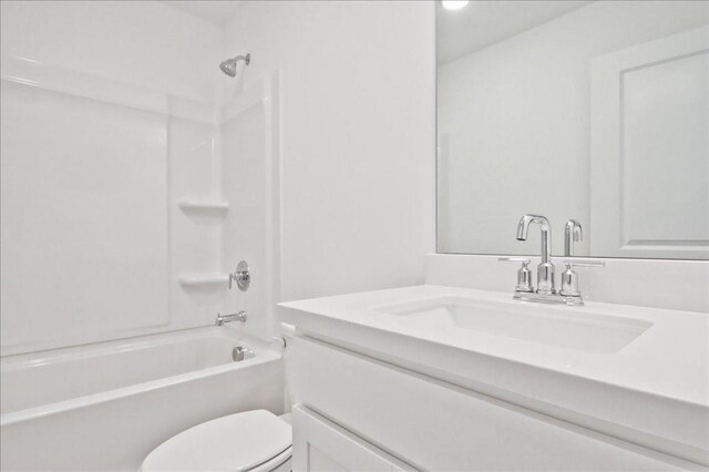 bathroom with vanity, toilet, and shower / bathtub combination