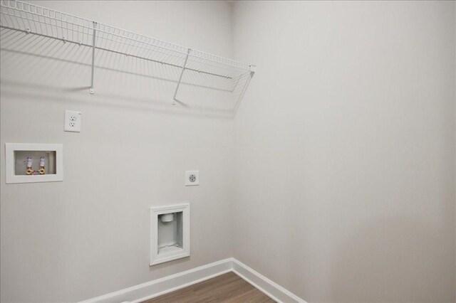 laundry room with dark wood-type flooring, baseboards, laundry area, hookup for a washing machine, and hookup for an electric dryer