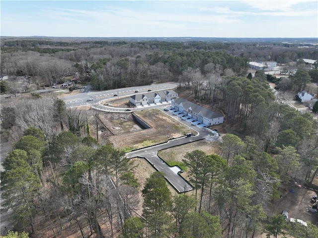 birds eye view of property featuring a wooded view