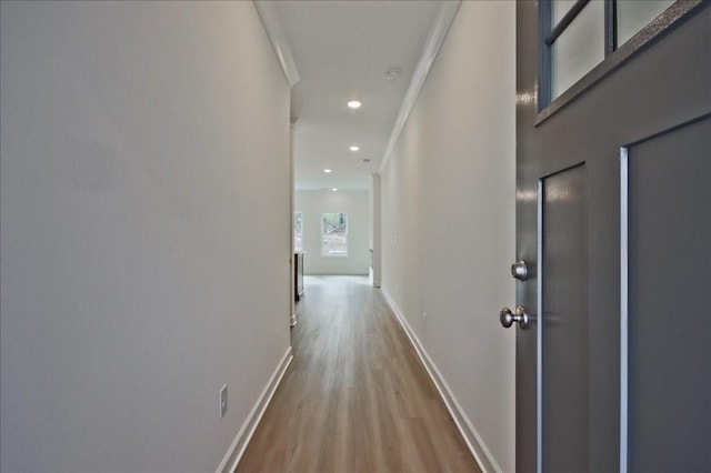 hall with recessed lighting, ornamental molding, baseboards, and wood finished floors