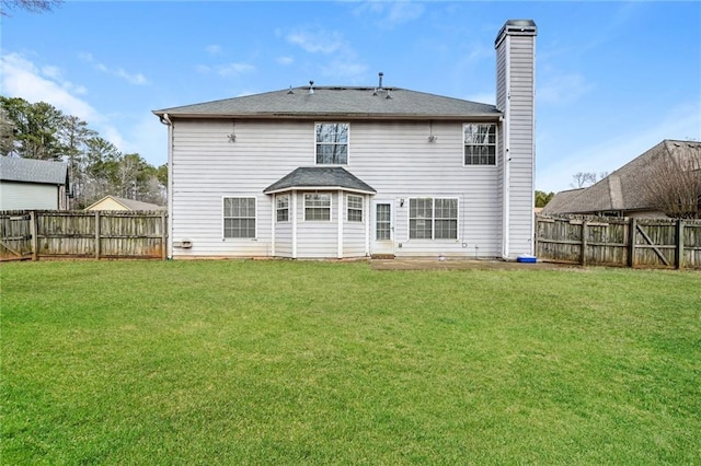 rear view of house with a lawn