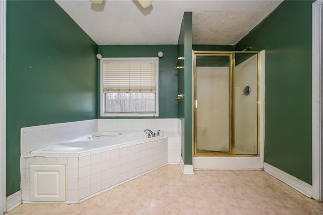 bathroom featuring ceiling fan, separate shower and tub, and a textured ceiling