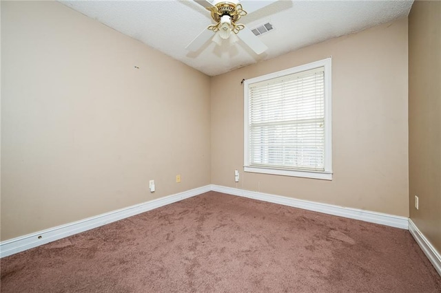 empty room with ceiling fan and carpet