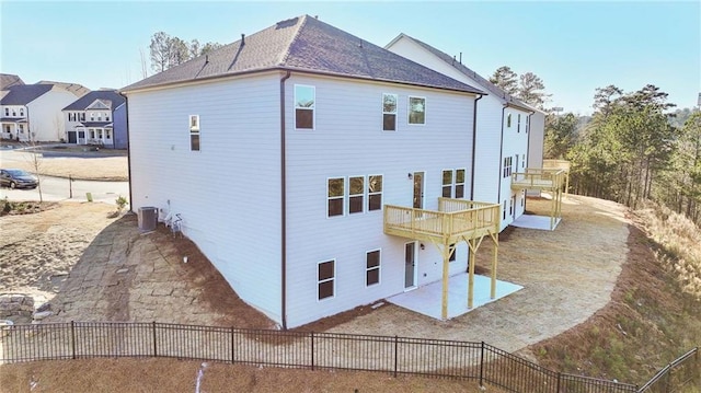 back of property with cooling unit, a patio, a deck, and fence