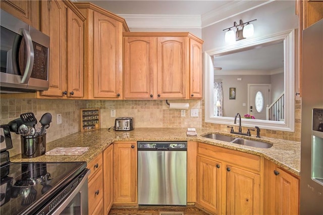 kitchen with light stone countertops, stainless steel appliances, ornamental molding, and sink