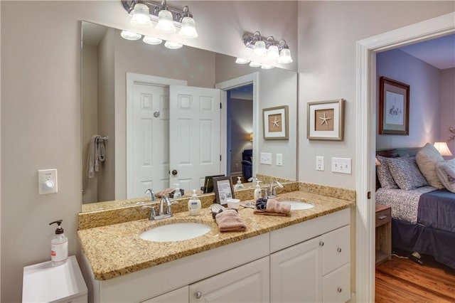 bathroom with hardwood / wood-style floors and vanity