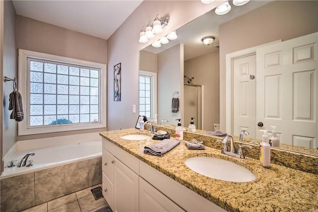 bathroom featuring plus walk in shower, tile patterned floors, and vanity