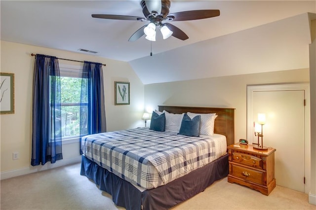 bedroom featuring ceiling fan, light colored carpet, and vaulted ceiling