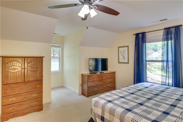 bedroom featuring ceiling fan, light colored carpet, and vaulted ceiling