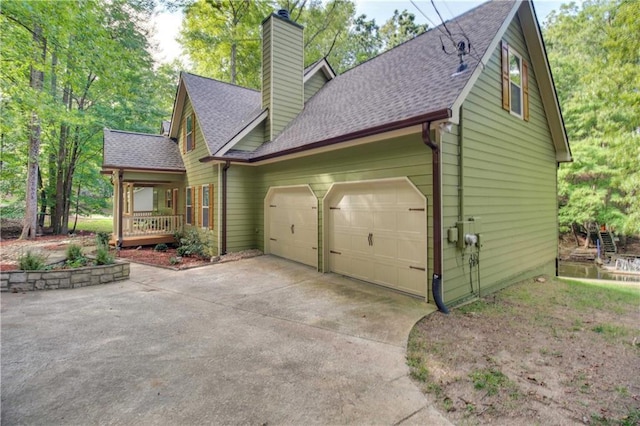 view of home's exterior with a garage and covered porch