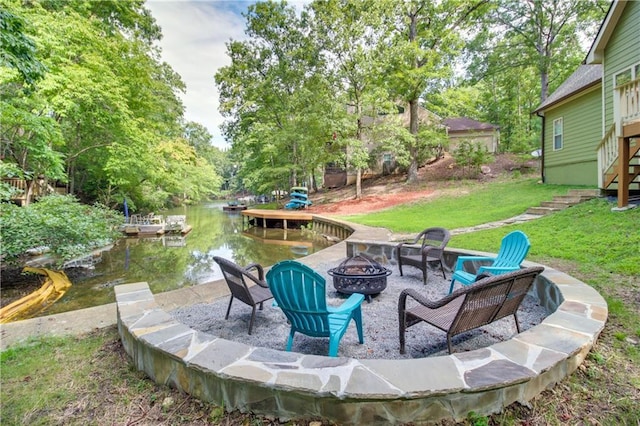 view of patio featuring a fire pit and a water view