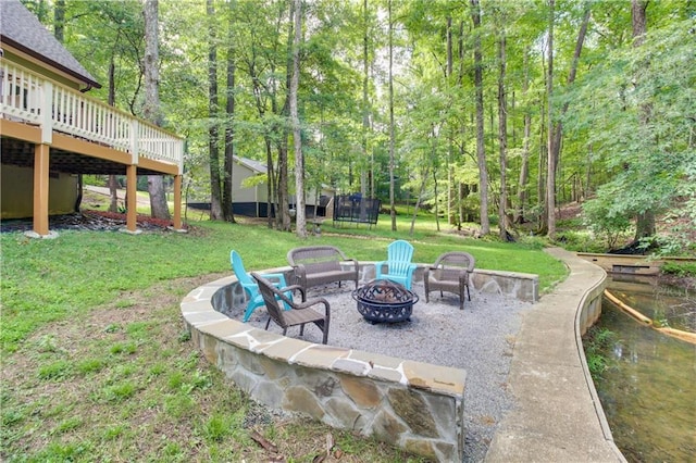 view of patio / terrace featuring an outdoor fire pit and a deck