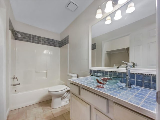 full bathroom with vanity, tile patterned floors, decorative backsplash, toilet, and shower / bathtub combination