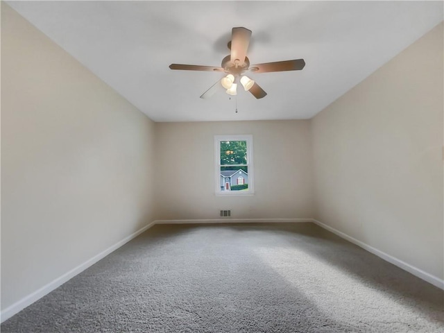 empty room with ceiling fan and carpet floors