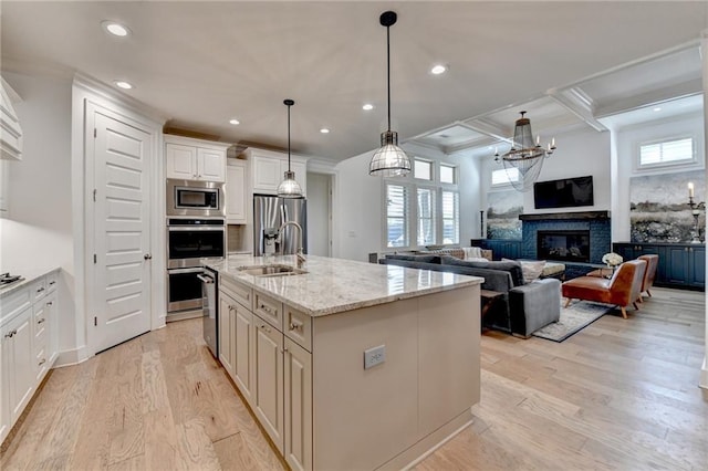 kitchen featuring a sink, coffered ceiling, stainless steel appliances, and recessed lighting